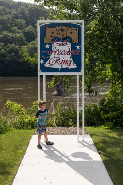 Boy ringing a replica of the Liberty Bell at the Sherman Memorial Lighthouse in Tionesta PA