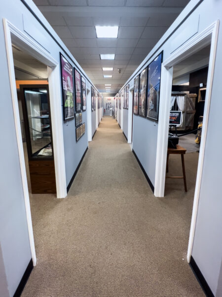 Long hallway with posters on it at The Living Dead Museum near Pittsburgh PA