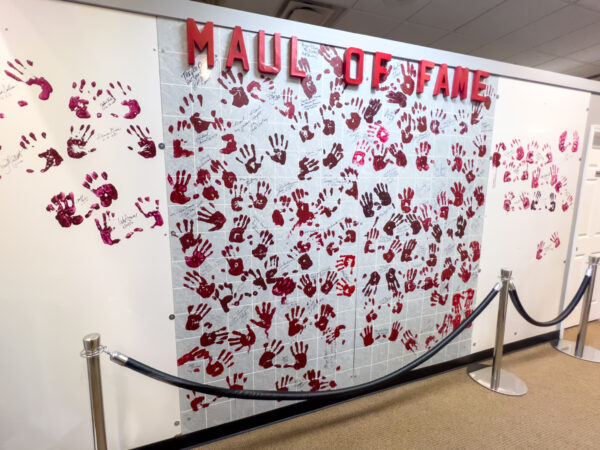 Wall with red handprints and a sign saying Maul of Fame at The Living Dead Museum near Pittsburgh Pennsylvania