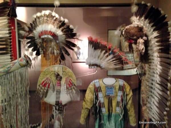 Native American headdresses and clothing on display while visiting the Carnegie Museum of Natural History.