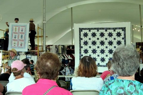 Quilts available for sale at an Amish Mud Sale in Lancaster County, PA.