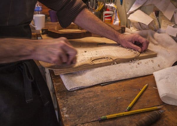 Mark Bluett works on a violin at Bluett Bros Violins Tour in York, Pennsylvania