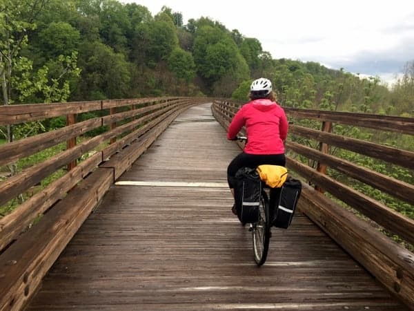 Woman biking on the Dunbar Creek Viaduct in Connellsville Pennsylvania.