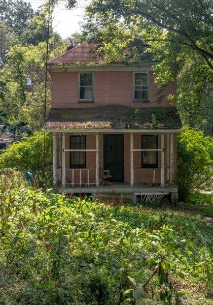 Home in Yellow Dog Village surrounded by underbrush