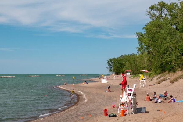 A lifeguard watching people sunbathing on the beach at Presque Isle State Park in Erie, PA