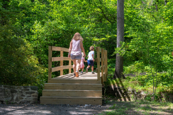 People walking at the Trailhead for the Mount Misery Trails in Valley Forge