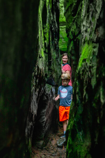 People going through a narrow rock passage at Bilger's Rocks in Clearfield County Pennsylvania