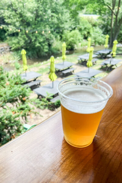 A glass of beer at Voodoo Brewing in State College on a ledge overlooking the beer garden.