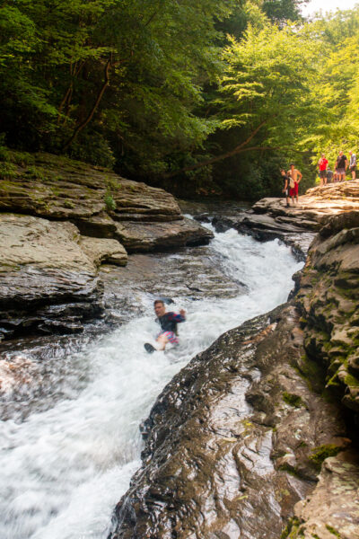 Person going down the Natural Waterslides in Ohiopyle State Park in PA