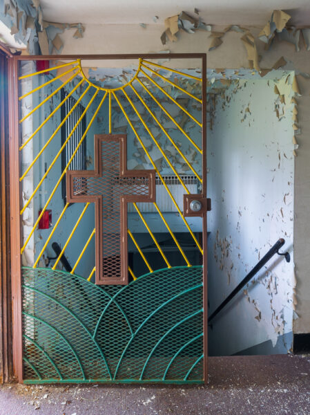 Colorful metal door with a cross at the abandoned Cresson Prison in Pennsylvania