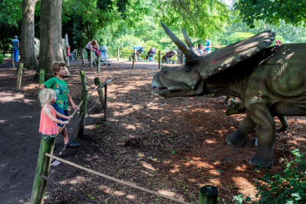 Kids looking at animatronic dinosaurs at Dutch Wonderland In Lancaster County Pennsylvania