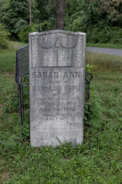 Grave of Sarah Ann Thomas Boone with the hooded grave behind the tombstone