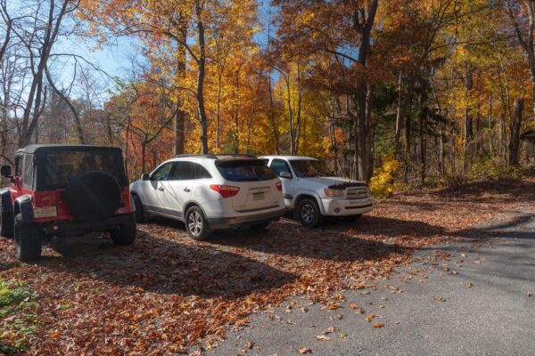 Cars sitting in the parking area for the sign at the halfway point of the Appalachian Trail