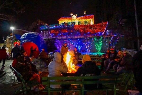 People sitting around a campfire at the Holiday Lights at Kennywood Christmas Light Display