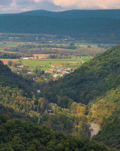 Looking through the hillsides to a small town from Penn's View Overlook in Bald Eagle State Forest in PA