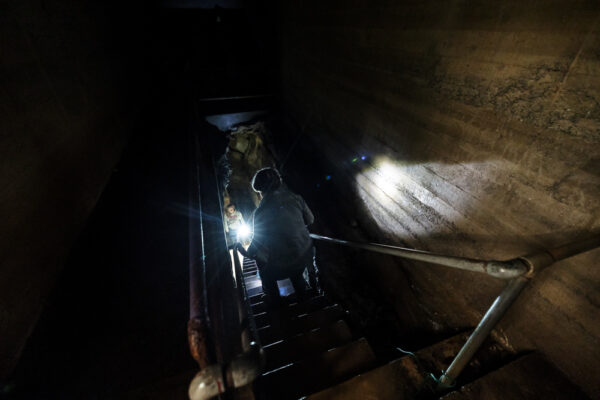 Woman descending steps into dark Black-Coffey Caverns near Greencastle PA