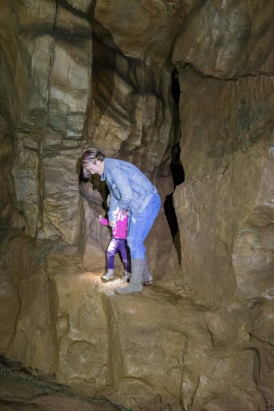 Woman and child exploring Black-Coffey Caverns in Pennsylvania