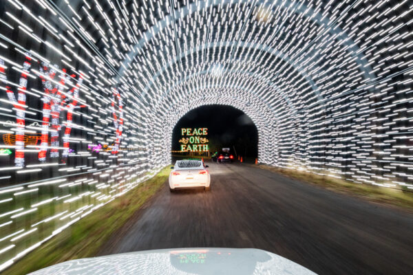 Car driving through a light tunnel at the Christmas light display at Shady Brook Farm in Yardley PA