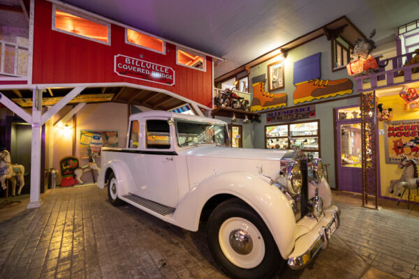 An antique car and covered bridge in Billville at Bills Old Bike Barn in Columbia County Pennsylvania