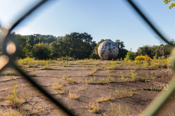 Looking through a chainlink fence towards the Westinghouse Atom Smasher in Pittsburgh PA