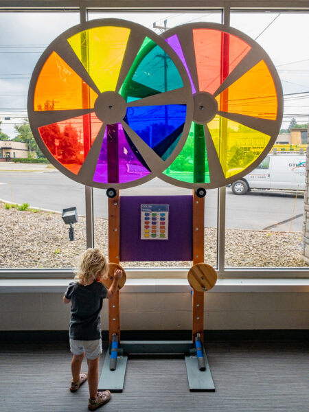 Young child playing with a colorful display at Discovery Space in State College, Pennsylvania