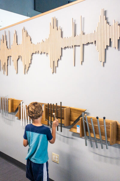 Boy playing an instrument at Discovery Space in State College Pennsylvania