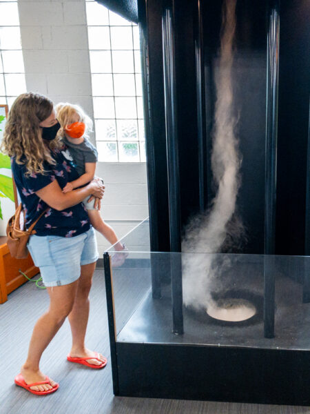 Woman and child next to a tornado at Discovery Space in Centre County PA