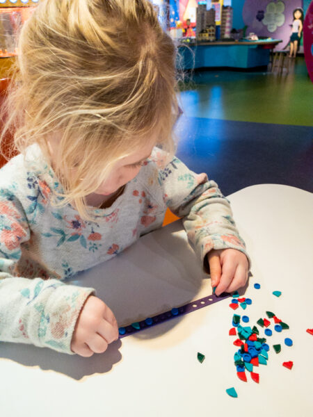 Girl making a bracelet at LEGOLAND near Philly