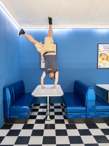 Man standing upside down at the Museum of Illusions in Philly.