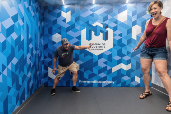 People in the Ames Room at the Museum of Illusions in Philadelphia, Pennsylvania