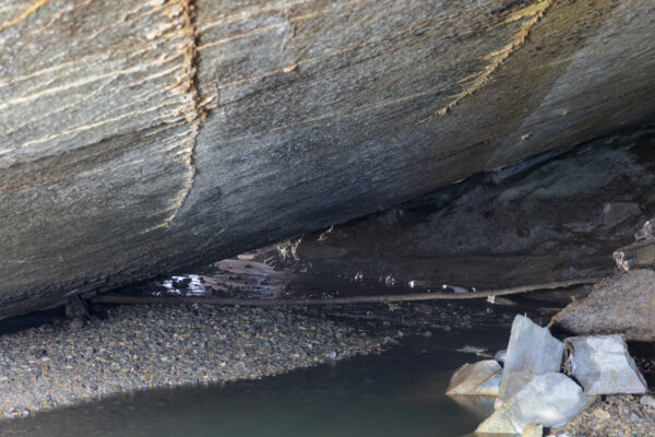 Inside Tytoona Cave with a stream at its base