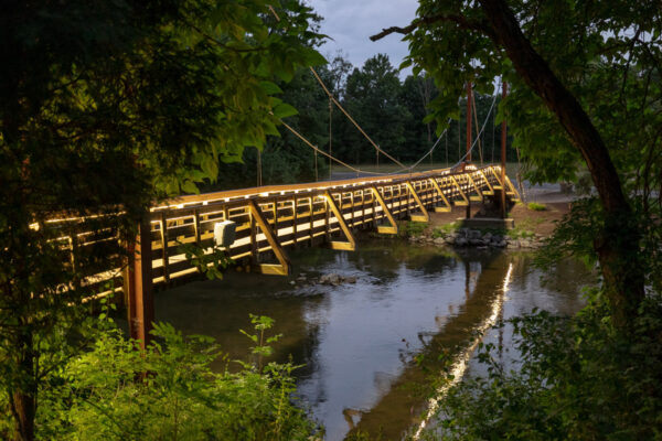 Another view of the swinging bridge at Messiah University in PA lit up at night.