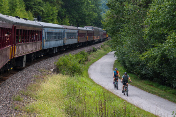 People biking on the D&L Trail next to the Lehigh Gorge Scenic Railway