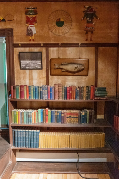 Bookshelf with Native Americans items on display above it at the Zane Grey Museum in the Poconos