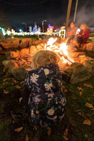 Child sitting in front of a bonfire at Overly's Country Christmas in Pennsylvania