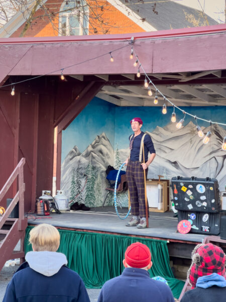 Man performing on stage and the Mifflinburg Christkindl Market in PA