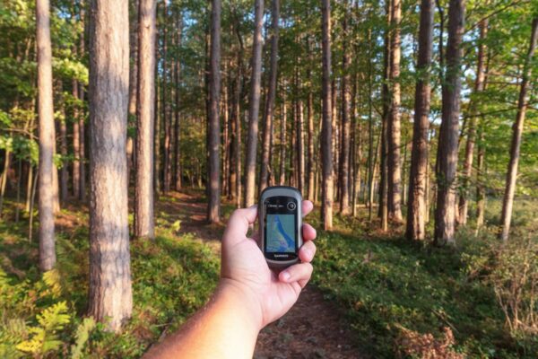 Man holding a GPS on a Black Moshannon Hiking Trail near State College PA