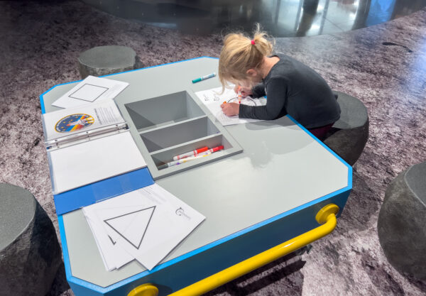 Child drawing a patch at the Moonshot Museum in Pittsburgh PA