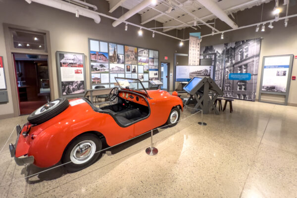 Vintage orange car in the middle of a room at the Hagen History Center in Erie PA