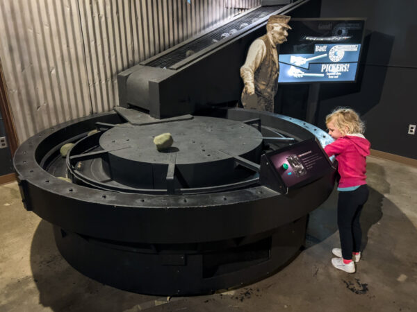 Child playing at a pretend coal sorter at the Heritage Discovery Center in Johnstown PA