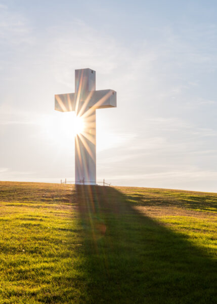 The sun sets behind the Great Cross of Christ in Jumonville PA