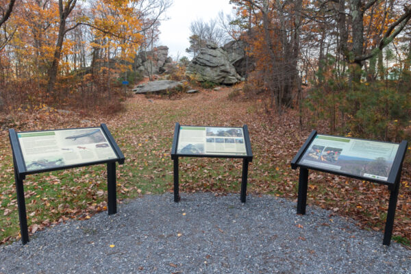 Three information signs in front of Hammonds Rocks in Michaux State Forest in Pennsylvania