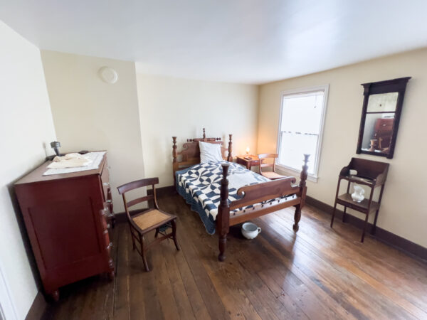 Room at the John Brown House in Chambersburg where Brown is said to have slept. Room includes a bed, a dresser, and a window.