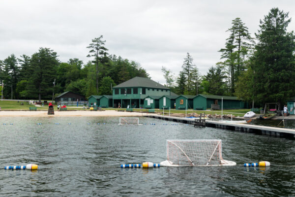 Swimming equipment in the water next to the dock and sand at Eagles Mere Beach in Pennsylvania