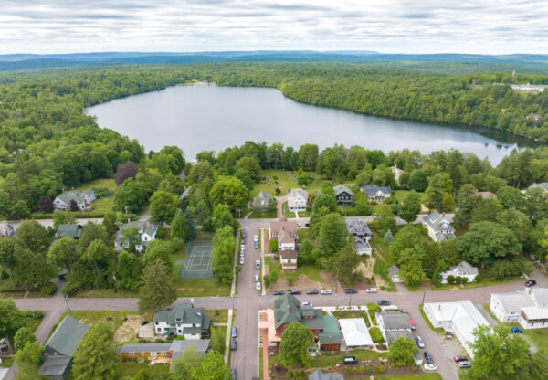Drone photo above Eagles Mere, PA showing the town and Eagles Mere Lake, both surrounded by forest