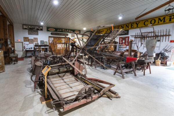 Antique farming equipment in a large room at the Heritage Village and Farm Museum in Troy PA