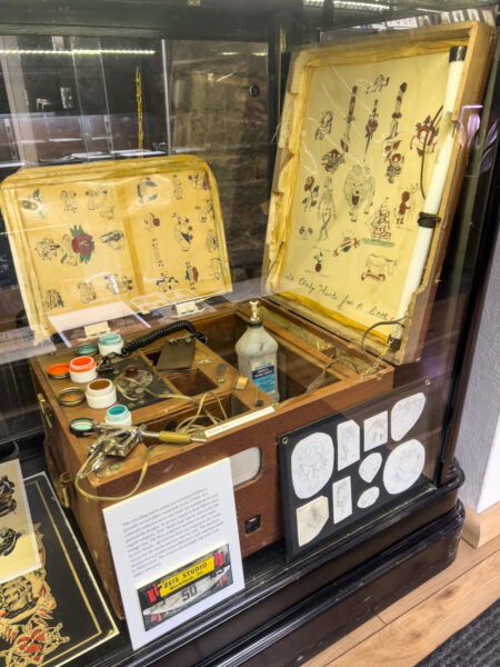 Historic tattooing machine on display in a case at the Pittsburgh Tattoo Art Museum in Shadyside