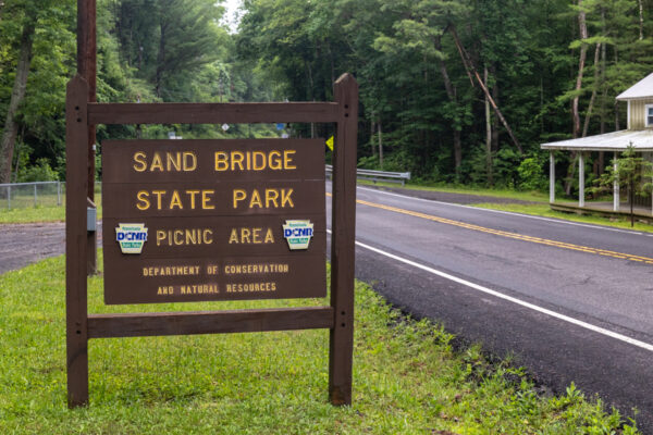Wooden sign along the road for Sand Bridge State Park in Union County PA