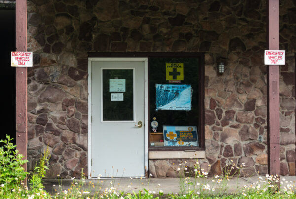 Signs cover the door of the ski patrol area at the abandoned ski resort in Denton Hill State Park in Pennsylvania