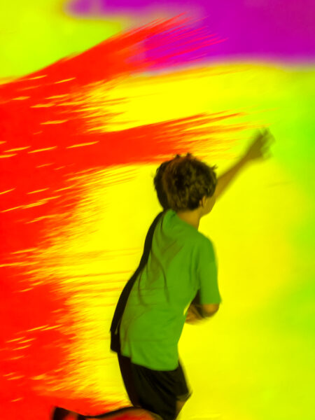 Child running in front of a colorful wall at WonderSpaces in Philadelphia PA
